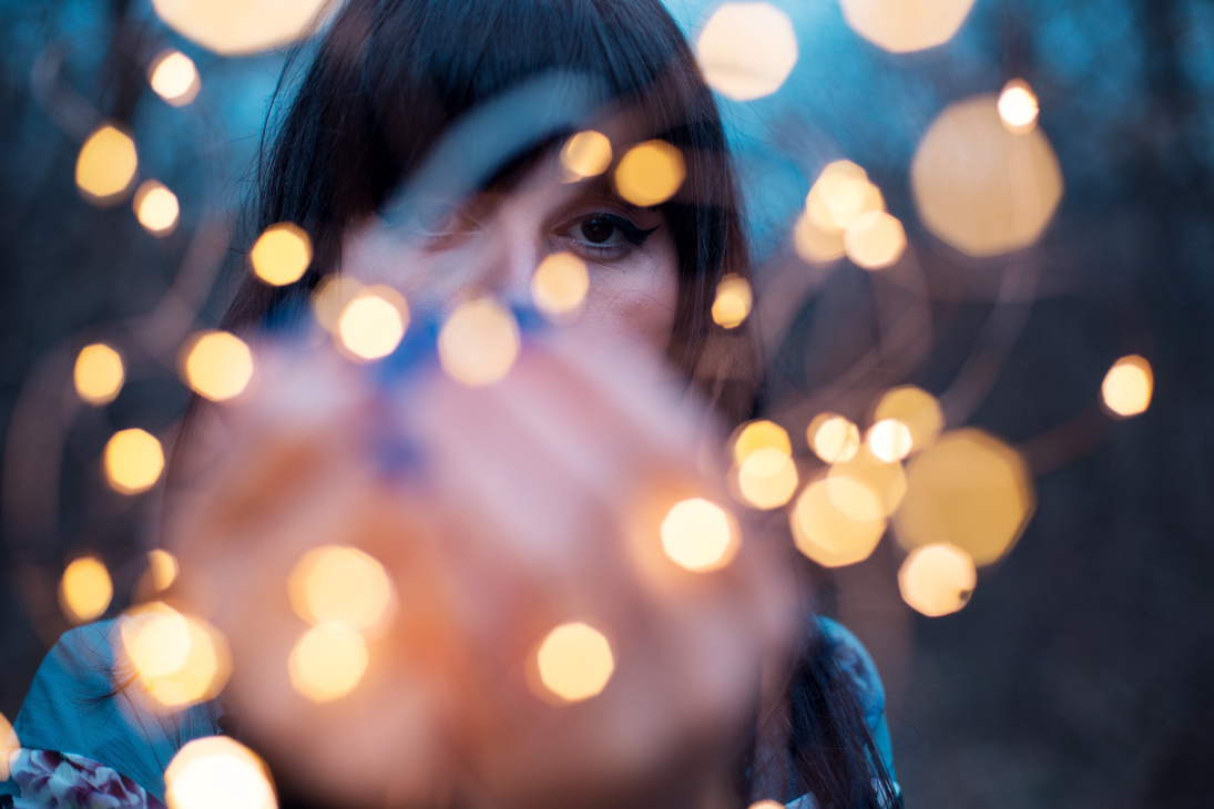 Sad woman with magic lights